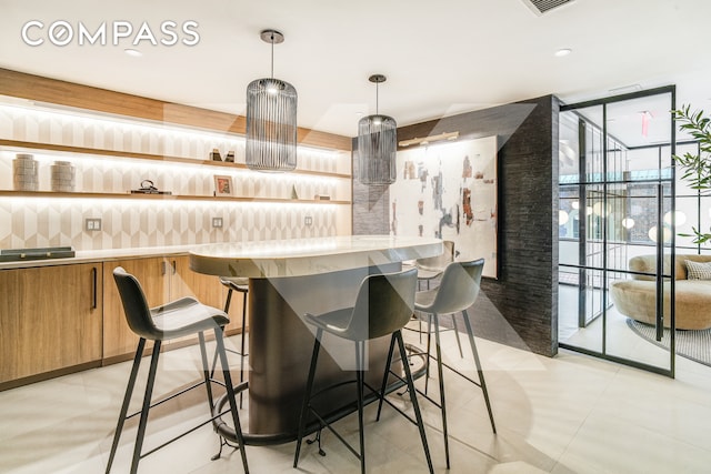 400 E 67th St Unit 3Cd, New York City, NY 10065 - bar area featuring floor to ceiling windows, hanging light fixtures, and light tile patterned floors