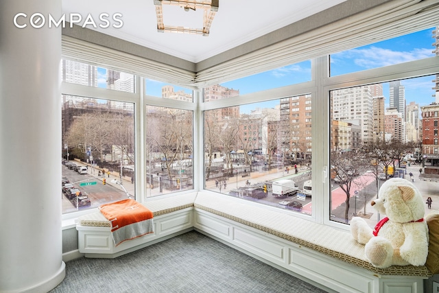 unfurnished sunroom featuring a view of city and a healthy amount of sunlight