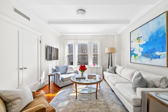 living area with beamed ceiling, wood finished floors, and crown molding