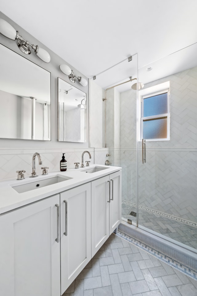 215 W 88th St Unit 11Ab, New York City, NY 10024 - bathroom with a shower stall, double vanity, tile walls, and decorative backsplash