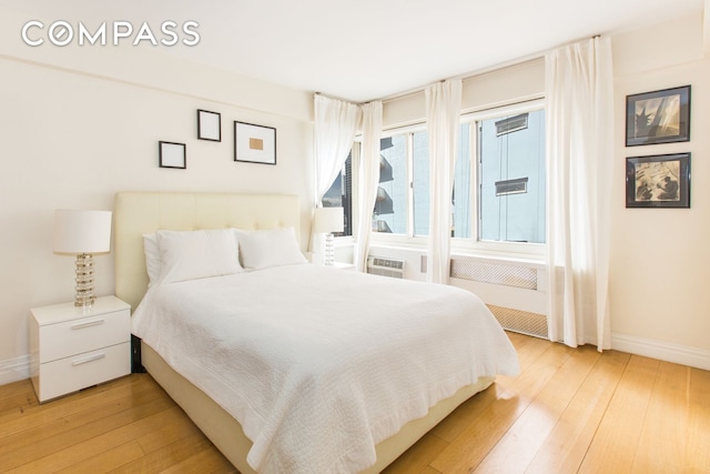 249 E 48th St Unit 16E, New York City, NY 10017 - bedroom featuring light wood-type flooring and baseboards