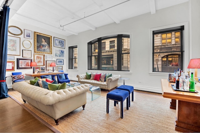 9 W 20th St Unit 2, New York City, NY 10011 - living room featuring wood finished floors, baseboard heating, and beamed ceiling