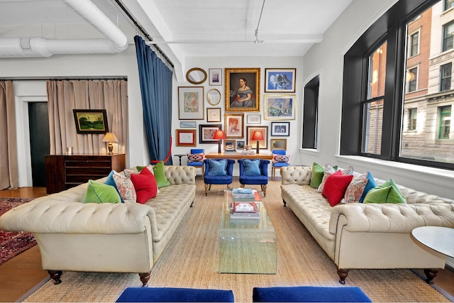 living room with arched walkways, rail lighting, and wood finished floors