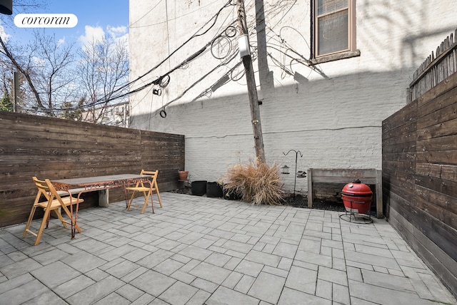 view of patio / terrace with fence and a fire pit