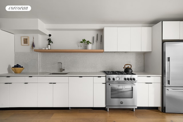 kitchen featuring open shelves, modern cabinets, and high end appliances