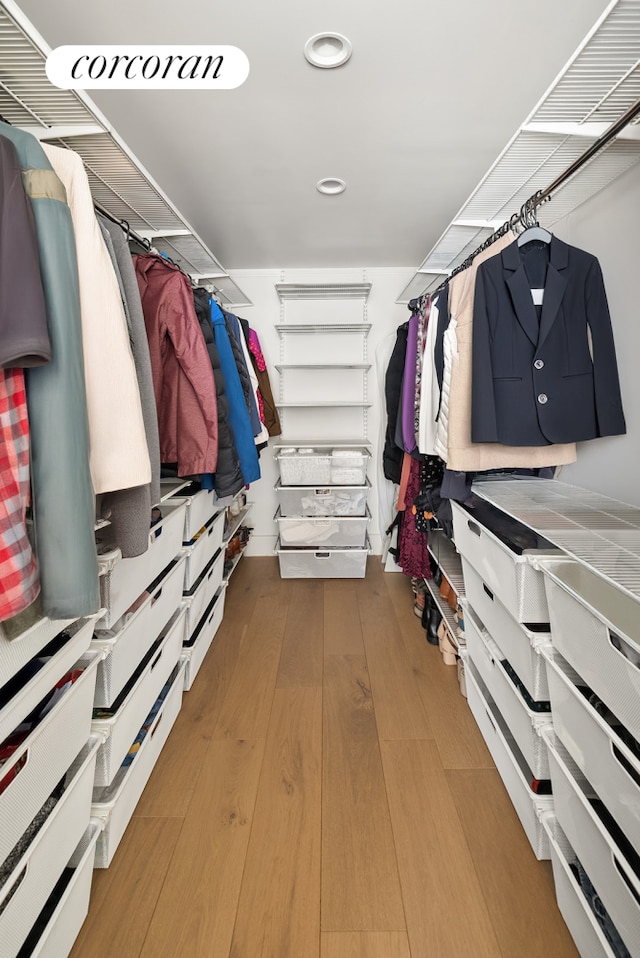 walk in closet featuring wood finished floors