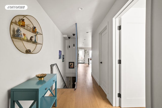 hall featuring recessed lighting, an upstairs landing, light wood-style flooring, and visible vents