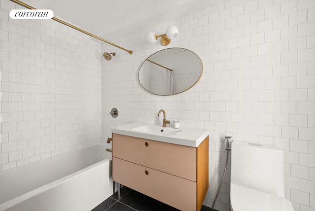 full bathroom featuring toilet, tile walls, bathing tub / shower combination, and vanity