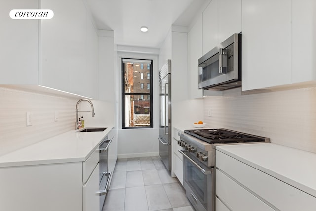 24 W 69th St Unit 6B, New York City, NY 10023 - kitchen with high quality appliances, modern cabinets, light countertops, and white cabinets