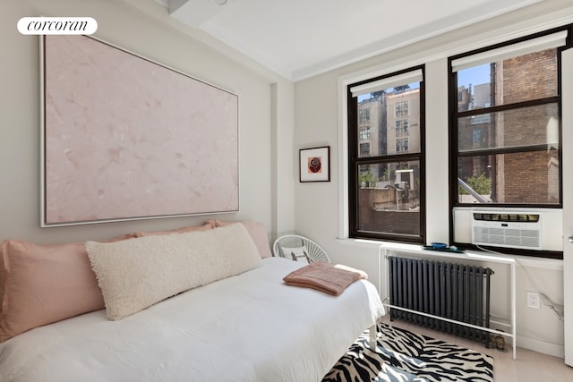 24 W 69th St Unit 6B, New York City, NY 10023 - bedroom featuring radiator, cooling unit, and wood finished floors