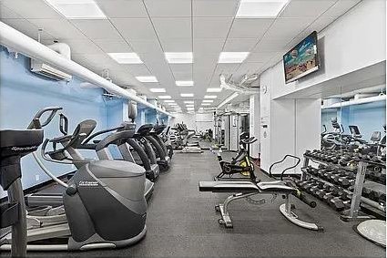 exercise room featuring a drop ceiling