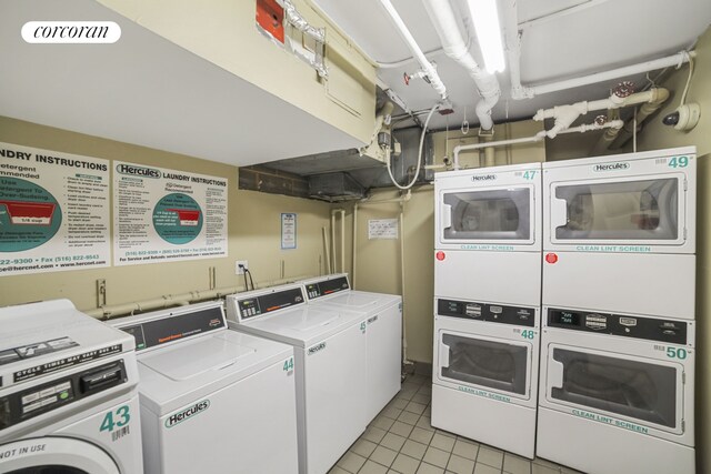 393 W 49th St Unit 3M, New York City, NY 10019 - shared laundry featuring estacked washer and dryer, washing machine and clothes dryer, and light tile patterned floors