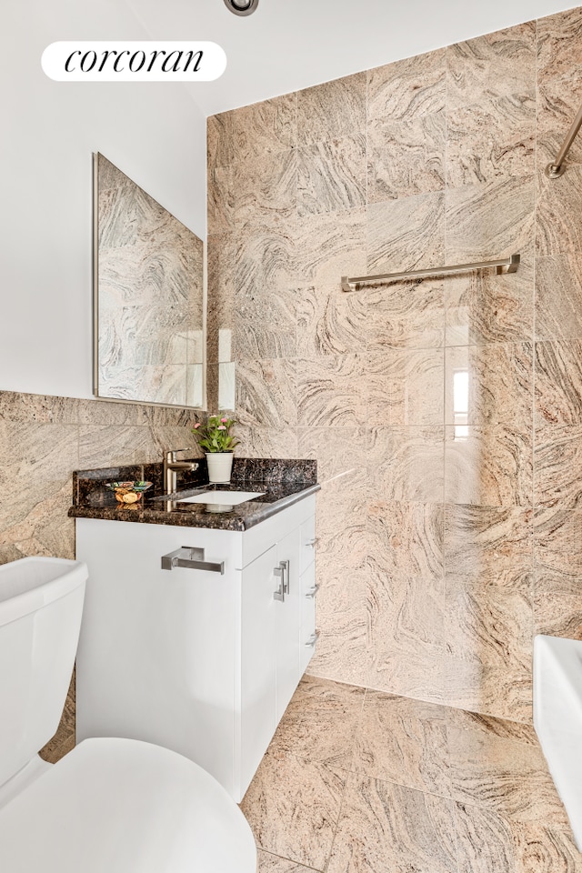 150 Joralemon St Unit 11D, New York City, NY 11201 - full bathroom featuring tile walls, toilet, and vanity