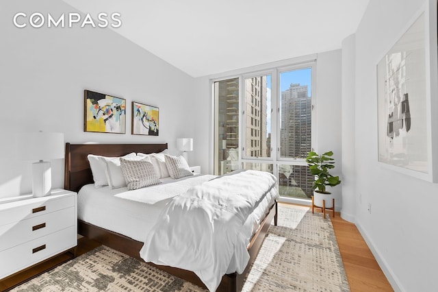 301 E 61st St Unit 16A, New York City, NY 10065 - bedroom with wood finished floors and baseboards