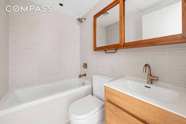 42 Rochester Ave Unit 3, New York City, NY 11233 - full bathroom with tile walls, washtub / shower combination, vanity, and decorative backsplash