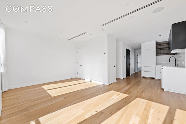 42 Rochester Ave Unit 3, New York City, NY 11233 - unfurnished living room with light wood-style flooring and baseboards