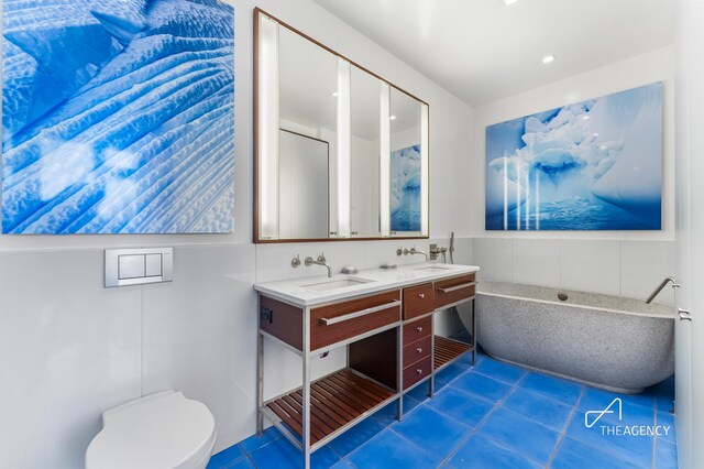 200 11th Ave Unit 7S, New York City, NY 10011 - full bath featuring tile patterned flooring, toilet, and double vanity