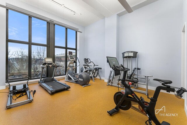 200 11th Ave Unit 7S, New York City, NY 10011 - workout area featuring healthy amount of natural light, baseboards, a high ceiling, and track lighting