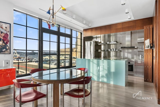200 11th Ave Unit 7S, New York City, NY 10011 - dining room with rail lighting and light wood-style flooring