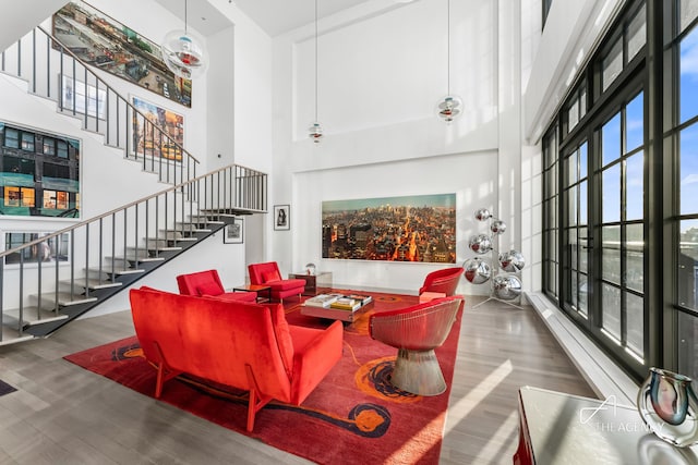 200 11th Ave Unit 7S, New York City, NY 10011 - living room with a high ceiling, wood finished floors, and stairway