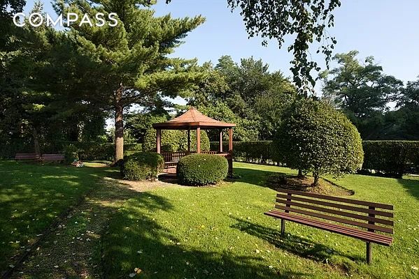 view of property's community with a yard, a gazebo, and fence