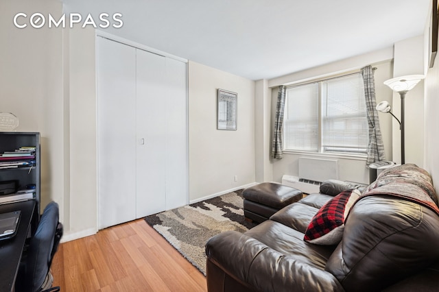 living room with baseboards and light wood-style floors