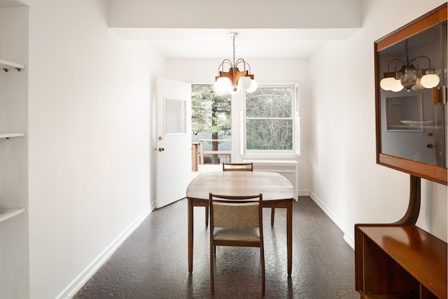dining area featuring a notable chandelier and baseboards