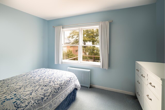 bedroom featuring carpet floors, radiator heating unit, and baseboards