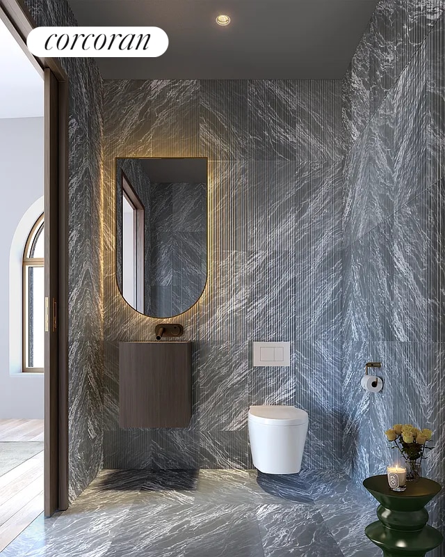 130 William St Unit 64B, New York City, NY 10038 - bathroom featuring marble tiled floors and toilet