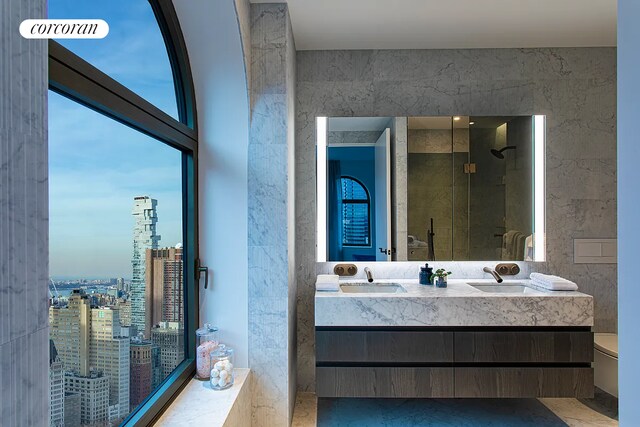 130 William St Unit 43C, New York City, NY 10038 - bathroom with double vanity, a shower stall, and a city view