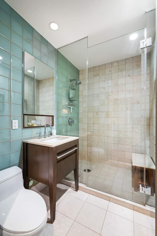 1600 Broadway Unit 18C, New York City, NY 10019 - full bath with tile walls, a shower stall, toilet, tile patterned floors, and vanity