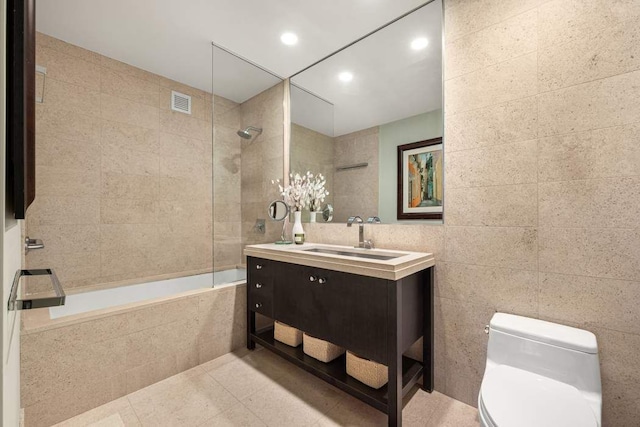 1600 Broadway Unit 18C, New York City, NY 10019 - full bathroom with tile walls, toilet, tile patterned floors, tiled shower / bath combo, and vanity
