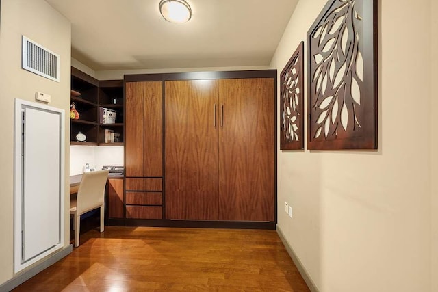1600 Broadway Unit 18C, New York City, NY 10019 - hallway with wood finished floors and a desk