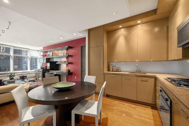 1600 Broadway Unit 18C, New York City, NY 10019 - kitchen featuring appliances with stainless steel finishes, light wood finished floors, light countertops, a sink, and recessed lighting