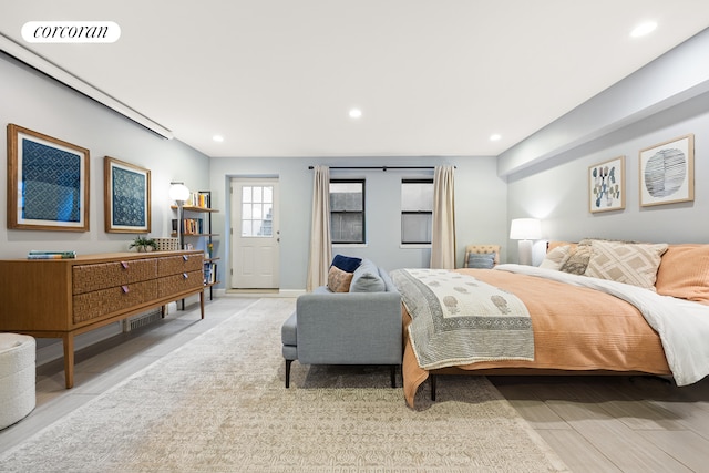 bedroom with recessed lighting and light wood finished floors
