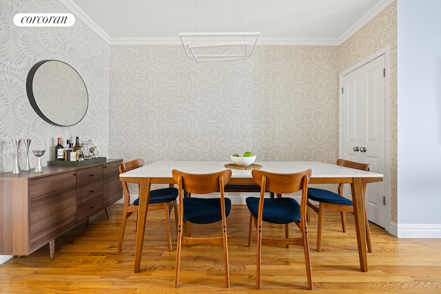 dining room with wallpapered walls, crown molding, light wood finished floors, and baseboards