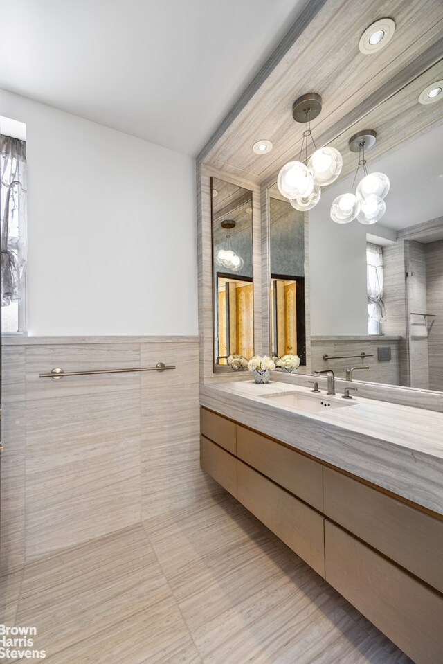 345 E 57th St Unit 8Ab, New York City, NY 10022 - full bathroom featuring tile walls, vanity, recessed lighting, and a wainscoted wall