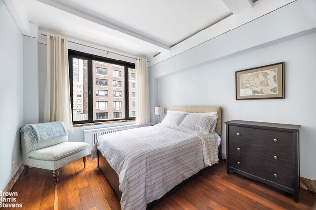 345 E 57th St Unit 8Ab, New York City, NY 10022 - bedroom with radiator heating unit and dark wood-style floors