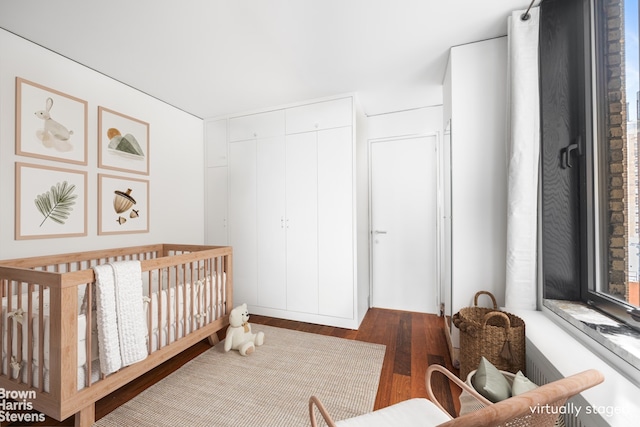 345 E 57th St Unit 8Ab, New York City, NY 10022 - bedroom with wood finished floors, a closet, and a crib
