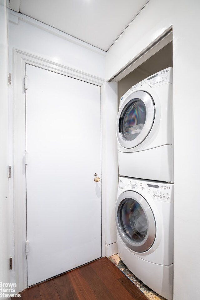 345 E 57th St Unit 8Ab, New York City, NY 10022 - laundry room with stacked washing machine and dryer and dark wood-style floors