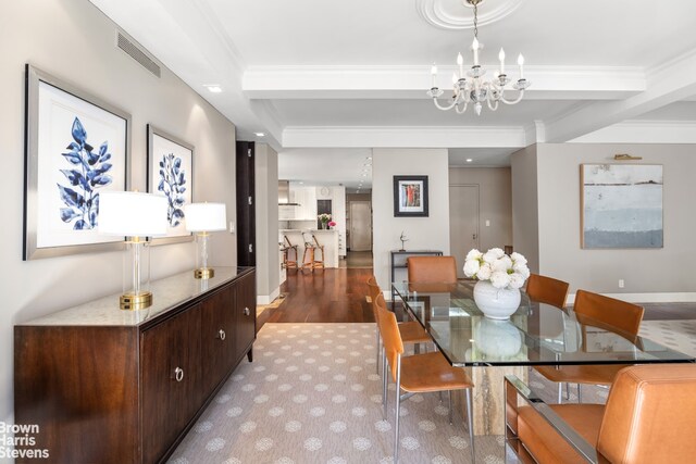 345 E 57th St Unit 8Ab, New York City, NY 10022 - carpeted dining room with ornamental molding, a chandelier, and wood finished floors