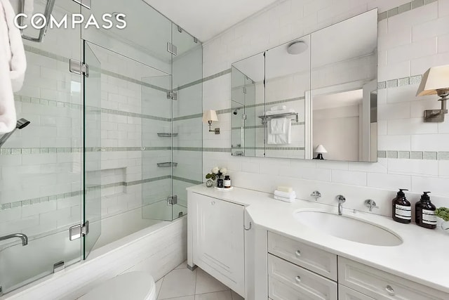 bathroom featuring vanity, toilet, tile walls, a shower stall, and backsplash