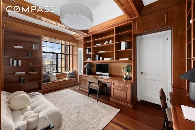 office area featuring beam ceiling, dark wood-style floors, built in desk, and coffered ceiling