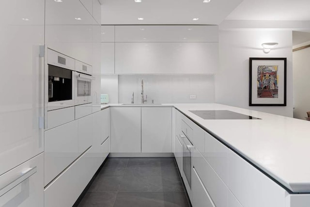 20 Sutton Pl S Unit 16/17Ef, New York City, NY 10022 - kitchen featuring modern cabinets, black electric stovetop, light countertops, white cabinetry, and a sink