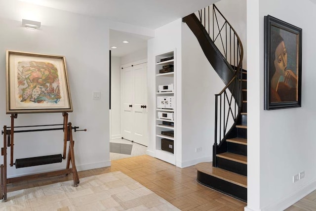 20 Sutton Pl S Unit 16/17Ef, New York City, NY 10022 - staircase featuring recessed lighting, baseboards, and built in features