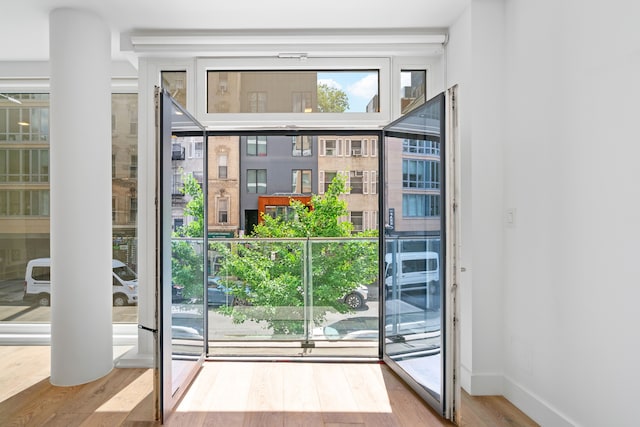 245 E 53rd St Unit 2, New York City, NY 10022 - doorway to outside featuring wood finished floors and baseboards