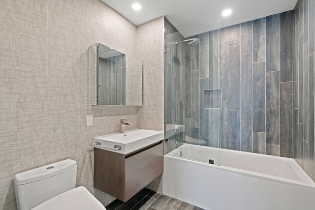 245 E 53rd St Unit 2, New York City, NY 10022 - bathroom featuring vanity, tile walls, shower / washtub combination, and toilet