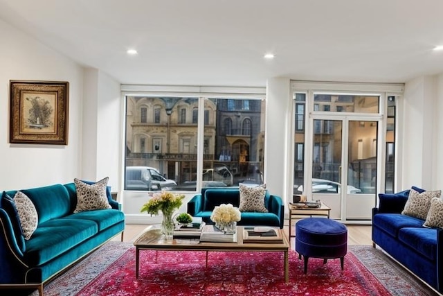 living area with wood finished floors, floor to ceiling windows, and recessed lighting