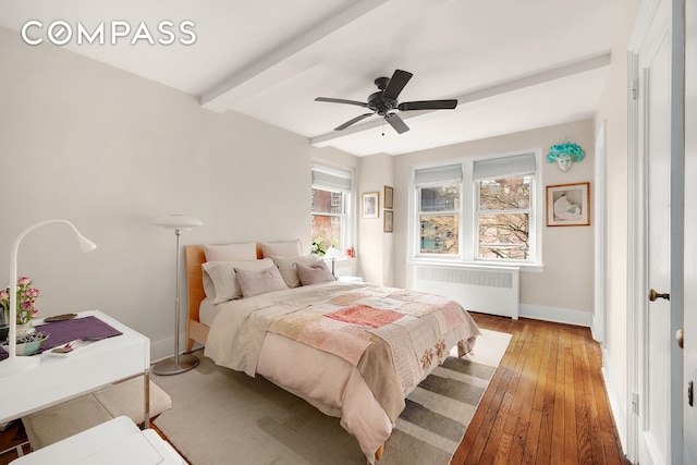 400 E 59th St Unit 3G, New York City, NY 10022 - bedroom featuring radiator heating unit, light wood-type flooring, beam ceiling, baseboards, and ceiling fan