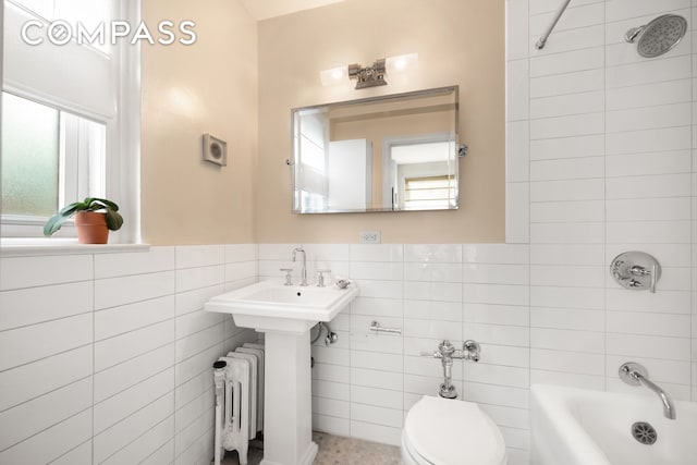 400 E 59th St Unit 3G, New York City, NY 10022 - full bathroom featuring radiator heating unit, tile walls, toilet, shower / bathtub combination, and a wainscoted wall